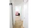 Clean hallway with light tile floors and access to bedrooms at 225 E Pomelo St, Lake Alfred, FL 33850