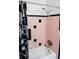 Bathroom with pink and black tile, shower/tub combo, and a vanity at 225 E Pomelo St, Lake Alfred, FL 33850