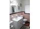Clean bathroom with pink and black tile and a vanity at 225 E Pomelo St, Lake Alfred, FL 33850