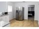 Bright kitchen boasting stainless steel refrigerator and view into living room at 225 E Pomelo St, Lake Alfred, FL 33850