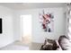 Living room with gray couch and large piece of artwork on the wall at 225 E Pomelo St, Lake Alfred, FL 33850