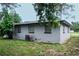 Rear view of a gray house with AC unit and yard at 225 E Pomelo St, Lake Alfred, FL 33850