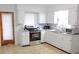 Efficient kitchen with white cabinets, stainless steel appliances, and tile flooring at 225 E Pomelo St, Lake Alfred, FL 33850