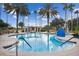 Relaxing community pool with palm trees and lounge area at 742 San Joaquin Rd, Poinciana, FL 34759