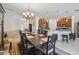 Bright dining room featuring a large table and chandelier, adjacent to a modern kitchen at 742 San Joaquin Rd, Poinciana, FL 34759