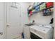 Laundry room with washer, dryer, and storage shelves at 742 San Joaquin Rd, Poinciana, FL 34759