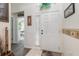 Bright entryway with white door, gray flooring, and access to another room at 170 Thornbury Dr, Kissimmee, FL 34744
