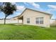 Tan house exterior with a large backyard at 170 Thornbury Dr, Kissimmee, FL 34744