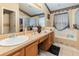 Bathroom with double vanity, bathtub and decorative accents at 170 Thornbury Dr, Kissimmee, FL 34744