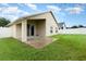 Tan house with a covered patio and fenced backyard at 170 Thornbury Dr, Kissimmee, FL 34744