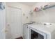 Laundry room with washer, dryer, and shelving for storage at 170 Thornbury Dr, Kissimmee, FL 34744
