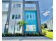 Modern two-story townhome with teal and white exterior at 7760 Sandy Ridge Dr # 214, Kissimmee, FL 34747