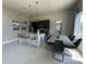 Contemporary kitchen featuring dark cabinetry, a breakfast bar, and a dining area at 7760 Sandy Ridge Dr # 214, Kissimmee, FL 34747