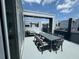 Spacious rooftop terrace with dining table and lounge chairs, offering city views at 7760 Sandy Ridge Dr # 214, Kissimmee, FL 34747