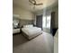 Spacious main bedroom with king-size bed, large window, and ceiling fan at 7760 Sandy Ridge Dr # 214, Kissimmee, FL 34747