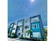 Modern townhome building with teal and white exterior at 7760 Sandy Ridge Dr # 214, Kissimmee, FL 34747