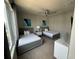 Bedroom with two twin beds, large windows, and ceiling fan at 7760 Sandy Ridge Dr # 214, Kissimmee, FL 34747