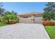 Two-car garage with paver driveway and landscaping at 154 Rancho Mirage Dr, Kissimmee, FL 34759