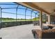 Large screened patio with lake view and seating at 154 Rancho Mirage Dr, Kissimmee, FL 34759