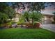 House with a beige exterior and lush landscaping at 154 Rancho Mirage Dr, Kissimmee, FL 34759
