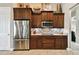 Well-equipped kitchen featuring stainless steel appliances and wood cabinets at 154 Rancho Mirage Dr, Kissimmee, FL 34759