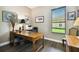 Bright home office with wood desk and window views at 154 Rancho Mirage Dr, Kissimmee, FL 34759