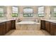 Elegant bathroom with soaking tub, double sinks, and tile flooring at 154 Rancho Mirage Dr, Kissimmee, FL 34759