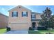 Two-story house with two-car garage and landscaping at 108 Country Walk Cir, Davenport, FL 33837