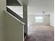 Living Room with carpeted floor, large window and access to the stairs at 108 Country Walk Cir, Davenport, FL 33837