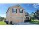 Two-story house with beige siding, brown shutters, and two-car garage at 108 Country Walk Cir, Davenport, FL 33837