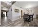 Dining area with a large table, chairs, wood-look tile floors, and access to the kitchen at 5051 Plymouth Turtle Cir, St Cloud, FL 34772