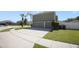 Two-story home exterior with a two-car garage, a driveway, and landscaping at 5051 Plymouth Turtle Cir, St Cloud, FL 34772