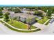 Aerial view of a two-story home with a green exterior, palm trees, and a landscaped yard at 5051 Plymouth Turtle Cir, St Cloud, FL 34772