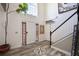 The home's entryway with tiled floors, a staircase, and decorative wall hangings at 5051 Plymouth Turtle Cir, Saint Cloud, FL 34772