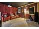 Dedicated home theater room with red leather recliner chairs, movie posters, and a popcorn machine at 5051 Plymouth Turtle Cir, St Cloud, FL 34772