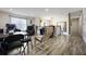 Upstairs living area with a seating area, table, and wood-look floors at 5051 Plymouth Turtle Cir, St Cloud, FL 34772