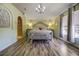 Large main bedroom with wood-look flooring, plush carpet, and an ensuite bathroom at 5051 Plymouth Turtle Cir, St Cloud, FL 34772