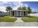 Green studio with double doors and windows, located in a backyard with grassy lawn at 5051 Plymouth Turtle Cir, St Cloud, FL 34772