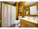 Small bathroom with shower and wood vanity at 5051 Plymouth Turtle Cir, St Cloud, FL 34772