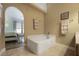 Bathroom featuring a large bathtub and access to bedroom at 5051 Plymouth Turtle Cir, St Cloud, FL 34772