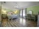 Primary bedroom with a large bed, dressing table and wood floors at 5051 Plymouth Turtle Cir, St Cloud, FL 34772