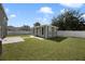 Green backyard studio with windows, situated beside a grassy lawn at 5051 Plymouth Turtle Cir, St Cloud, FL 34772