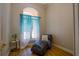 Relaxing office space with a chaise lounge and large window with sheer curtains at 4962 Lazy Oaks Way, St Cloud, FL 34771