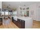 Open kitchen with large island, stainless steel appliances, and waterfront views at 4962 Lazy Oaks Way, St Cloud, FL 34771
