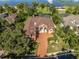 Aerial view showcases lakefront property with spacious home and driveway at 4962 Lazy Oaks Way, St Cloud, FL 34771