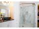 Bathroom with white cabinets, granite countertop, and a glass shower enclosure at 4962 Lazy Oaks Way, St Cloud, FL 34771