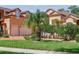Home features a two-car garage and lush landscaping at 4962 Lazy Oaks Way, St Cloud, FL 34771