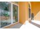 Front entry with double doors featuring pineapple stained glass and a welcome sign at 4962 Lazy Oaks Way, St Cloud, FL 34771