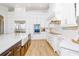 Modern kitchen with white cabinets, farmhouse sink, and quartz countertops at 4962 Lazy Oaks Way, St Cloud, FL 34771