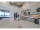 Gourmet kitchen boasts white cabinets, large island, and stainless steel appliances at 4962 Lazy Oaks Way, St Cloud, FL 34771